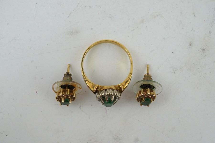 A yellow metal, emerald and diamond cluster set oval ring, size M and a pair of matching ear studs. Condition - poor to fair